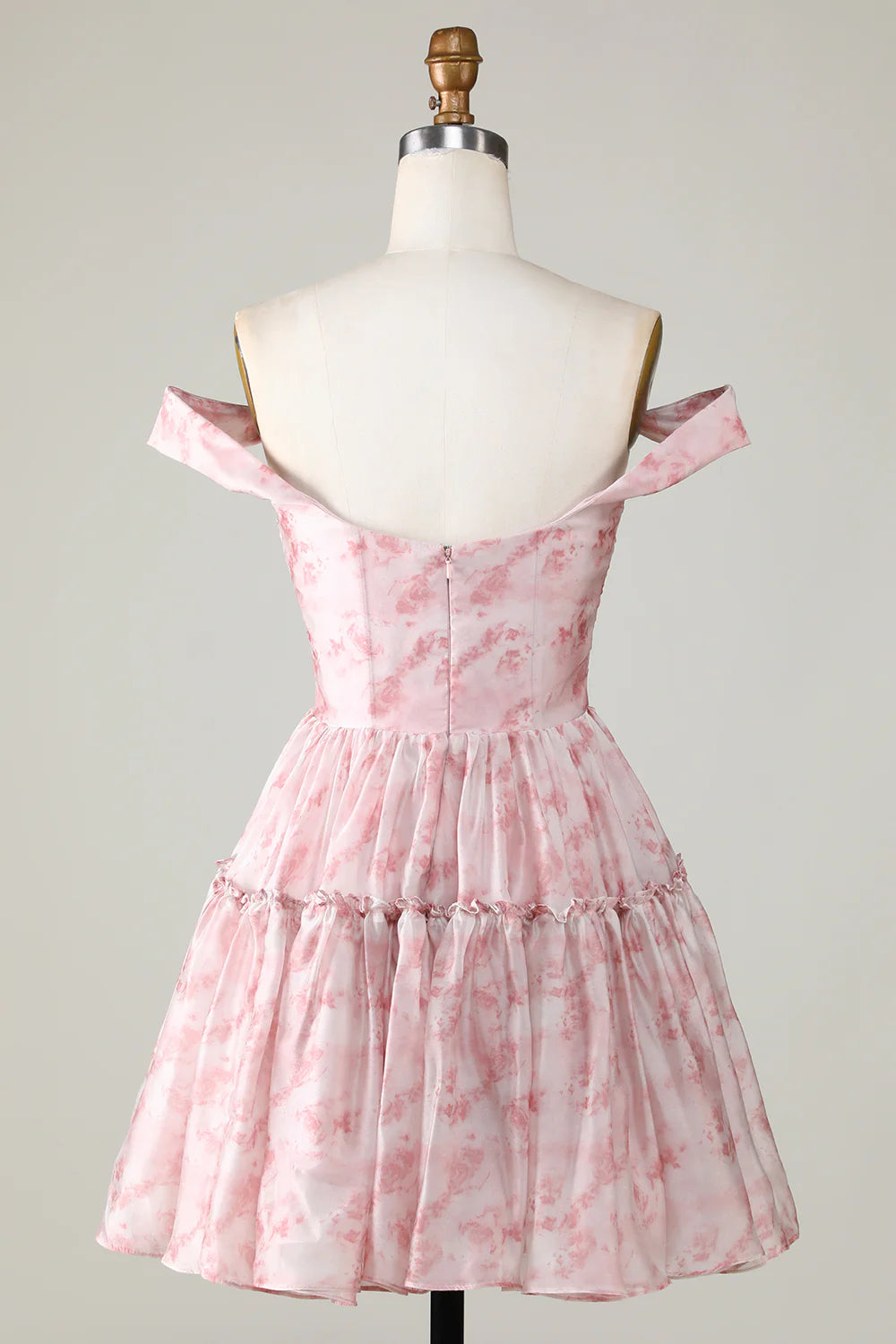 Back view of a blush A-line dress with ruffles.