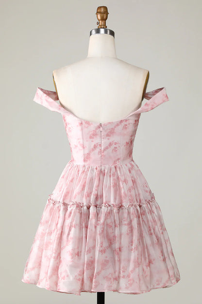 Back view of a blush A-line dress with ruffles.