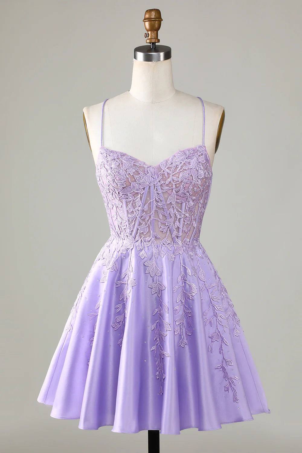 Model wearing a purple A-line satin homecoming dress with corset and lace details.