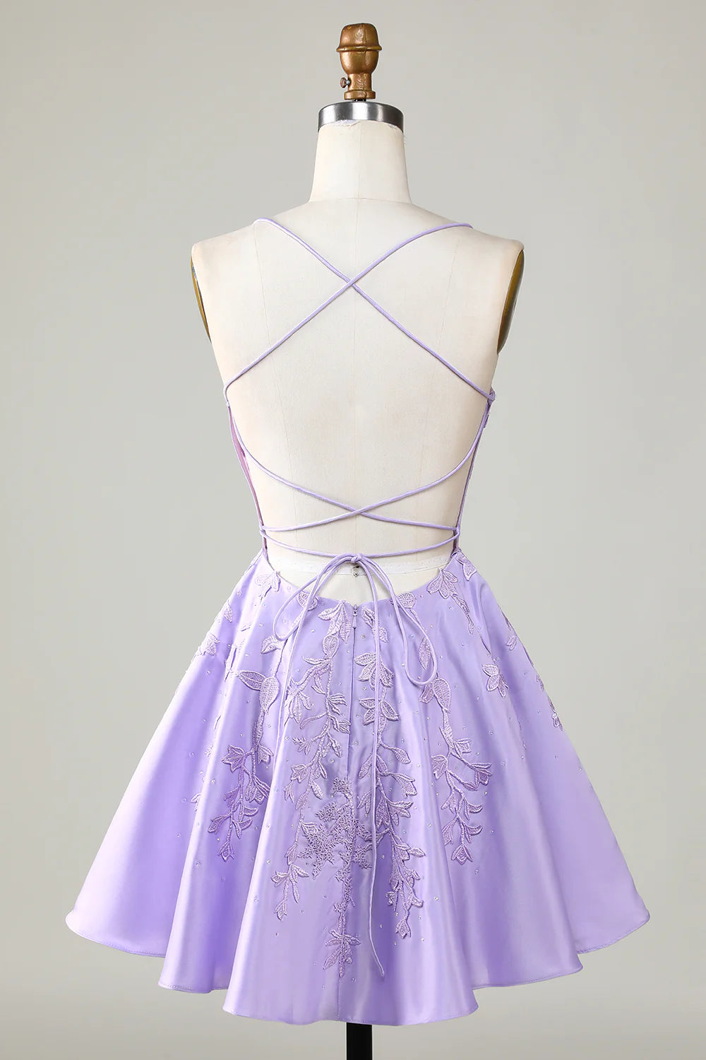 Back view of a model in a purple A-line satin homecoming dress.