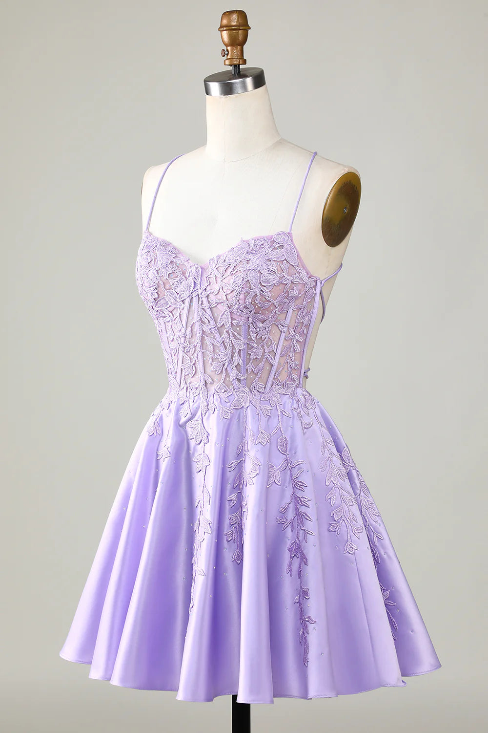 Side view of a model in a purple A-line satin homecoming dress.