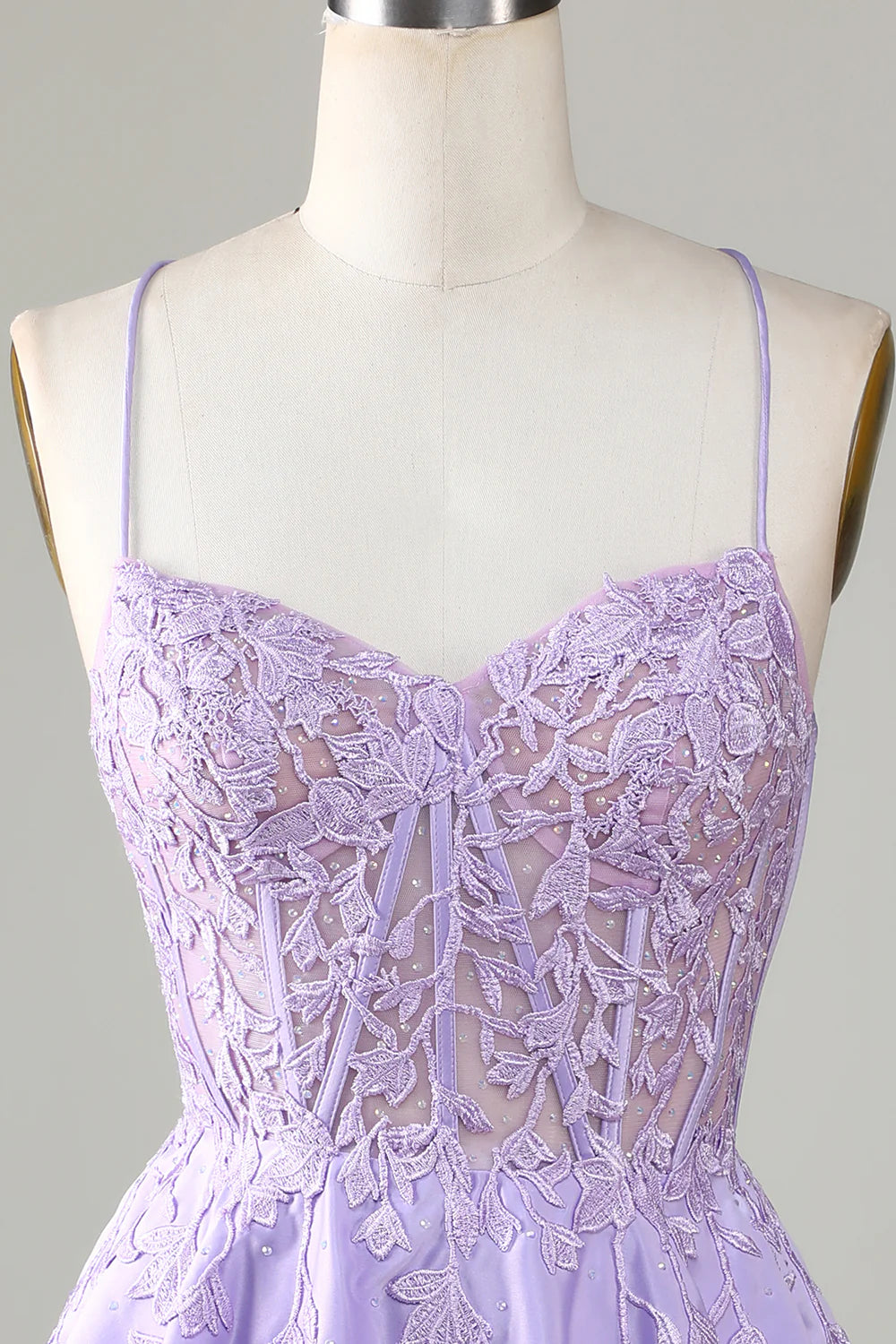 Close-up of the corset and lace details on a purple satin dress.