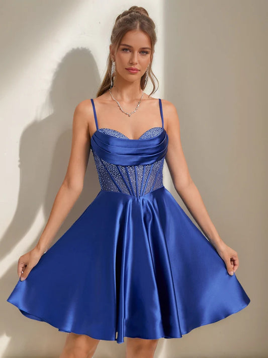 Front view of an elegant A-Line short homecoming dress with cowl straps and rhinestones.