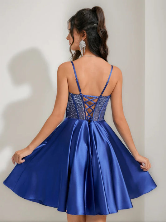 Side view of a model wearing the pleated A-Line short homecoming dress.