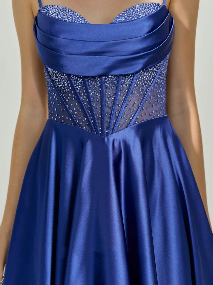Close-up of the cowl straps and rhinestone embellishments on the dress.