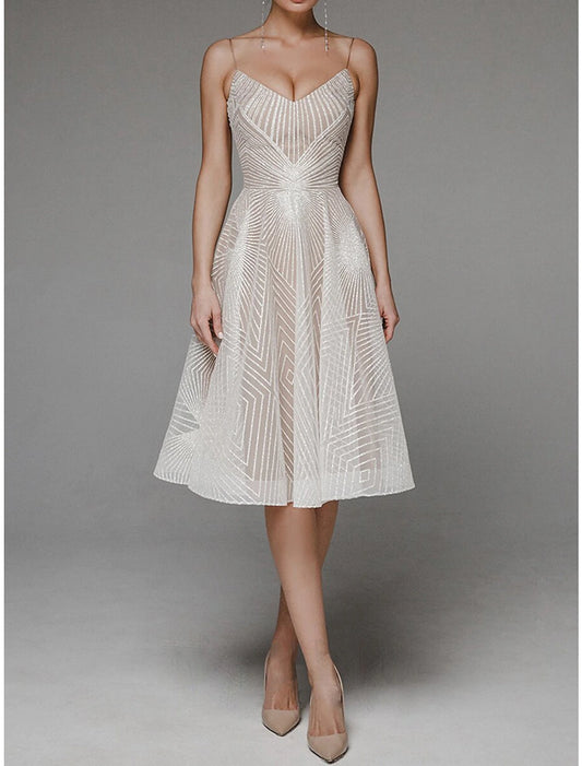A-Line floral embroidered tea-length dress with spaghetti straps.