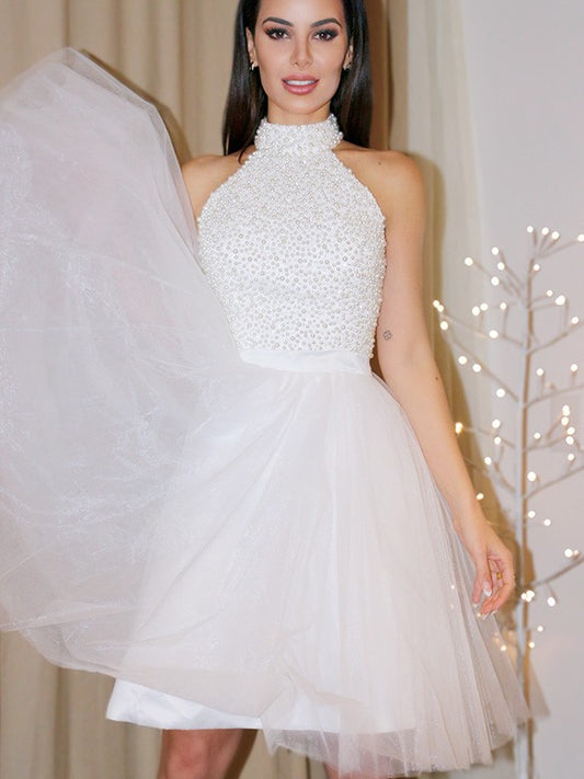Koutun A-Line halter mini homecoming dress with beading and tulle.