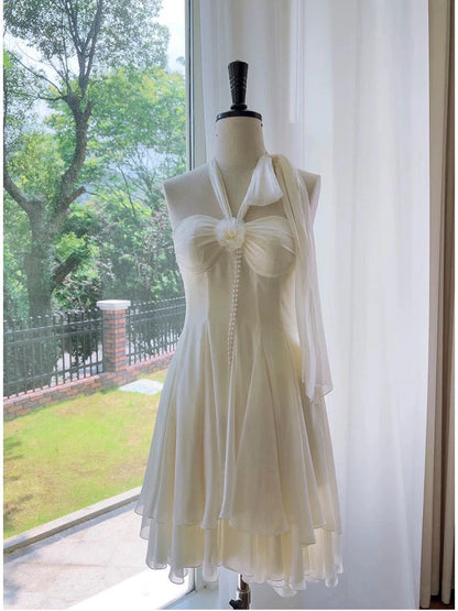 Front view of an elegant A-line halter neck chiffon short homecoming dress with bow and pearl detail.