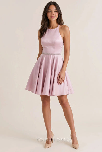 Model wearing a blush pink halter A-line mini homecoming dress.