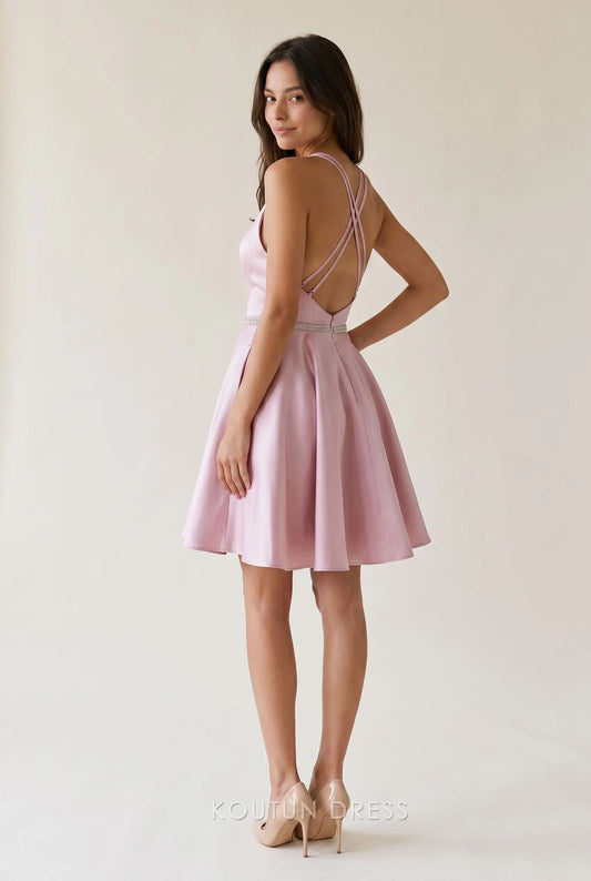 Side view of blush pink satin mini dress with halter neckline.