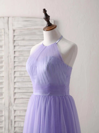 Back view of a woman wearing a short purple A-line halterneck tulle dress, highlighting the open back design.