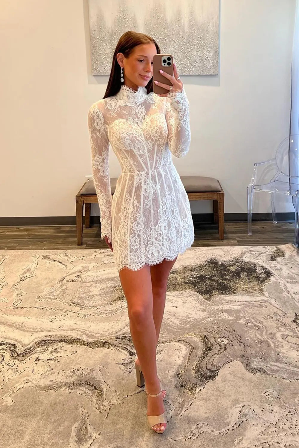 Close-up of the delicate lace fabric on the white high neck dress.