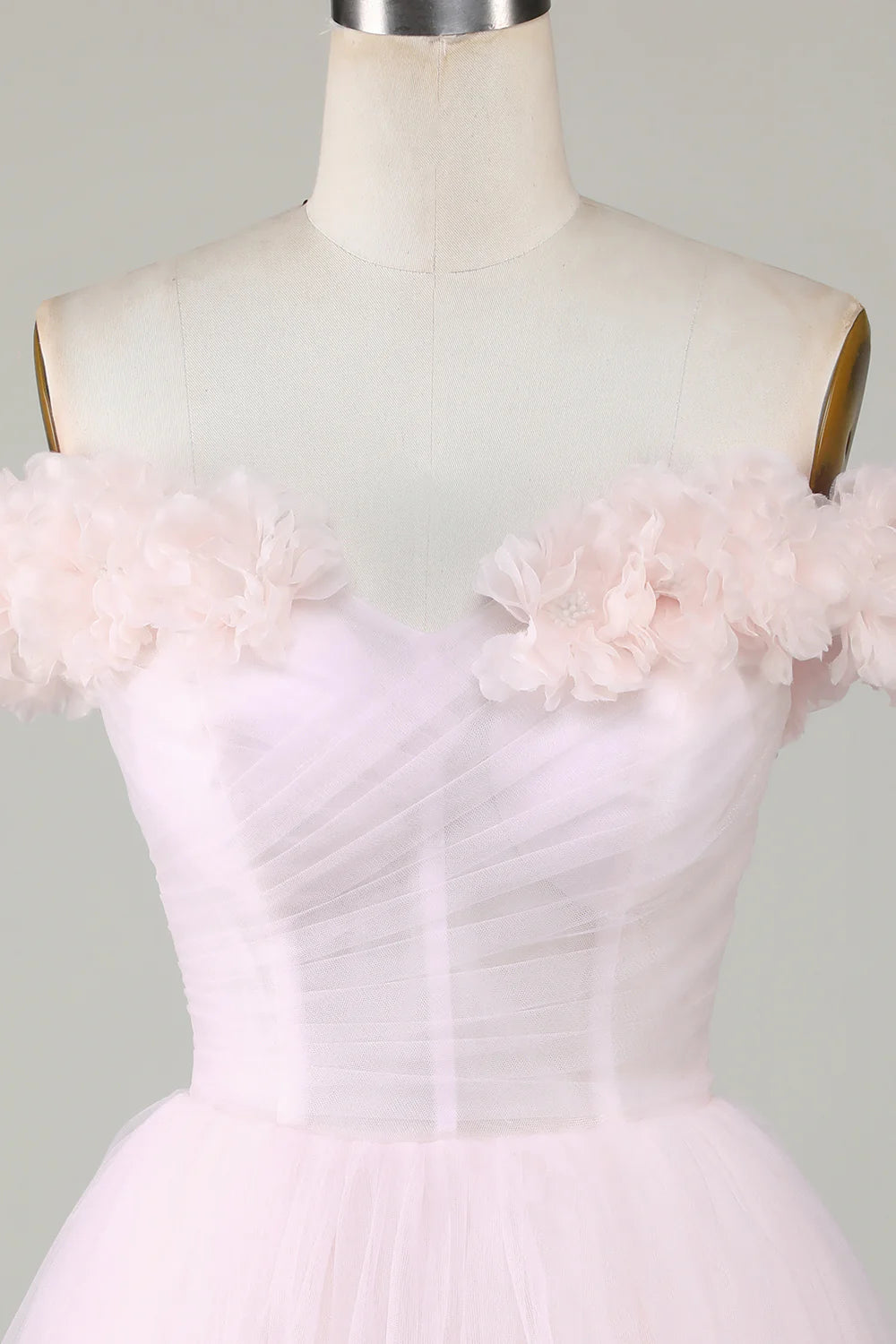 Back view of the pink off-shoulder homecoming dress with a flowing A-line skirt.