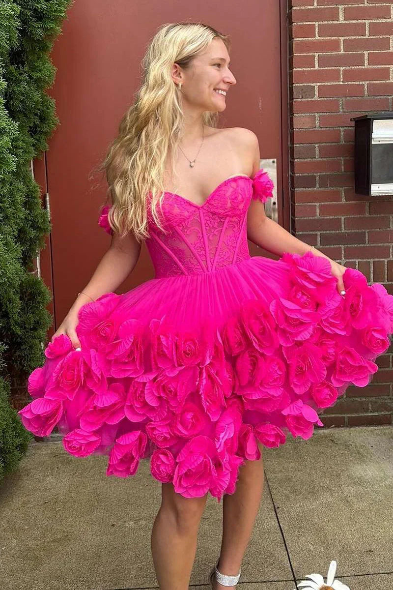Close-up of the floral embellishments on a pink satin off-shoulder dress.