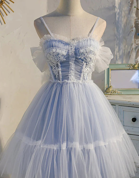 Model wearing a blue A-line off-shoulder pleated tulle homecoming dress.