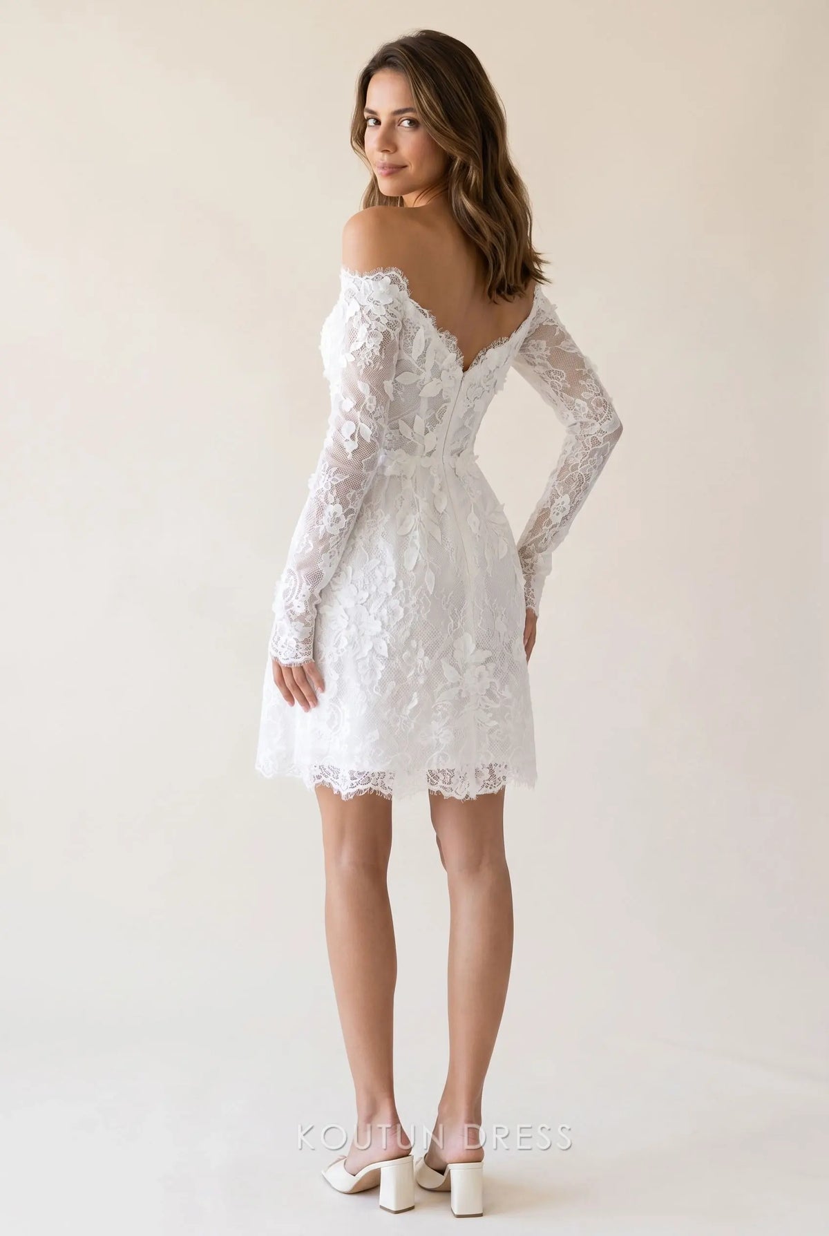 Back view of the white lace off-shoulder mini homecoming dress, showing the corset bodice and A-line skirt.