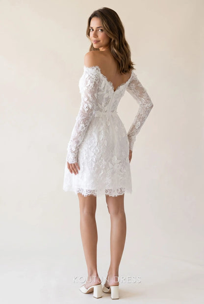 Back view of the white lace off-shoulder mini homecoming dress, showing the corset bodice and A-line skirt.