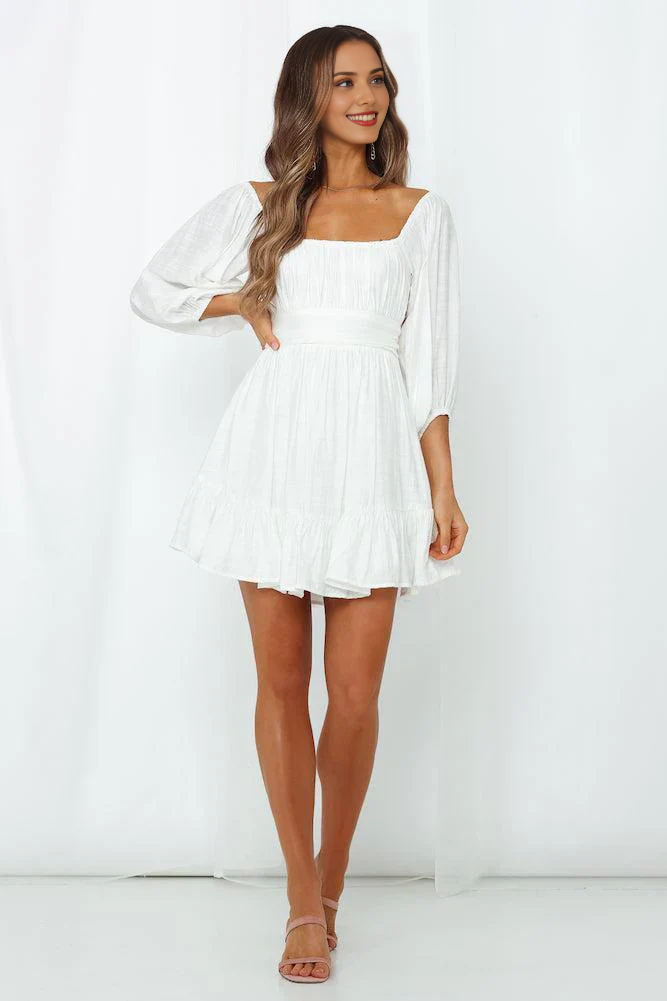 White A-line off-shoulder tiered mini dress.