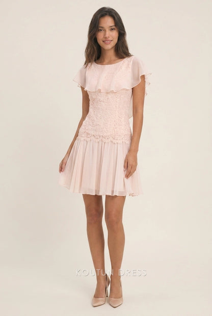 Close-up of lace bodice and ruffled flutter sleeve on blush pink dress.