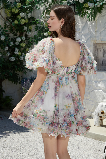 Side view of an ivory floral A-line short tulle dress with short sleeves.