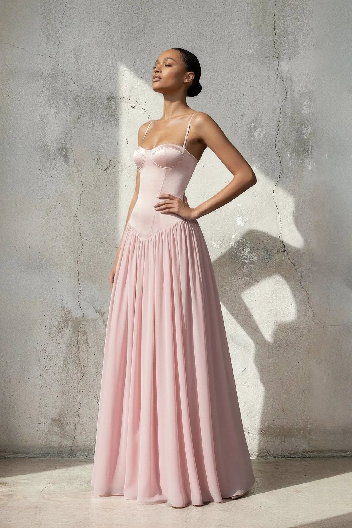 Side view of a woman wearing a floor-length A-line chiffon dress.