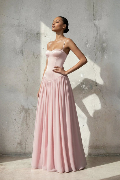 Side view of a woman wearing a floor-length A-line chiffon dress.