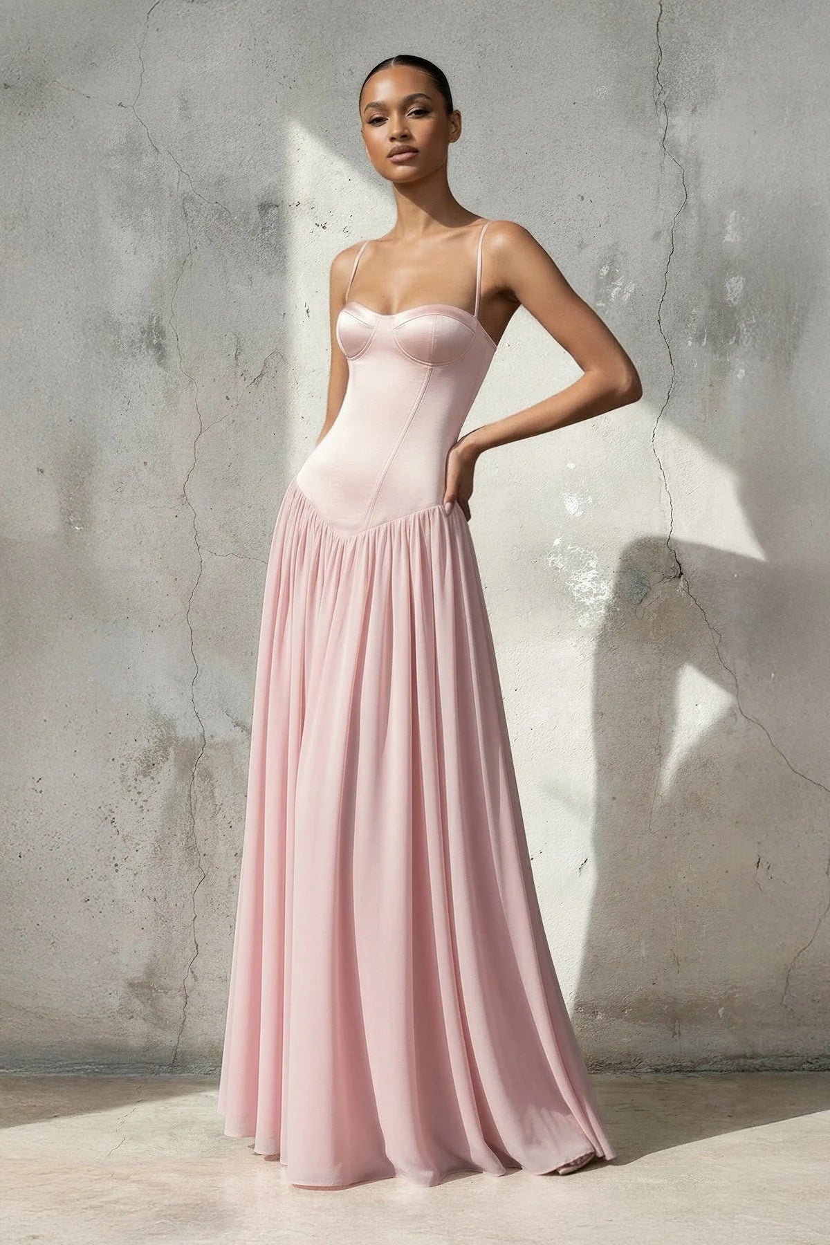 Full view of a woman in a spaghetti strap chiffon prom dress.