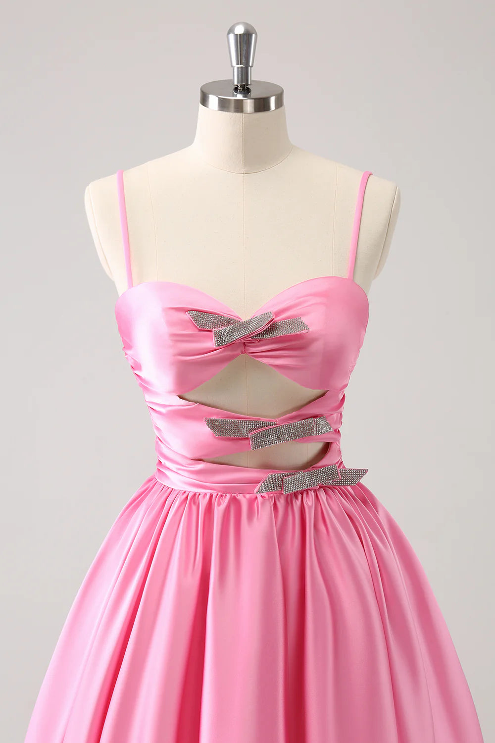 Model wearing a pink A-line homecoming dress, showcasing the keyhole detail.