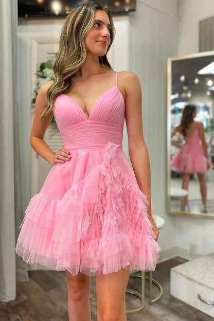 Model wearing an elegant pink A-line short homecoming dress with spaghetti straps and ruffles.