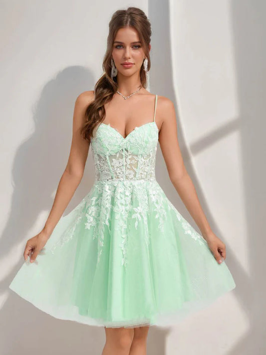 A-Line short homecoming dress with spaghetti straps and lace appliques.