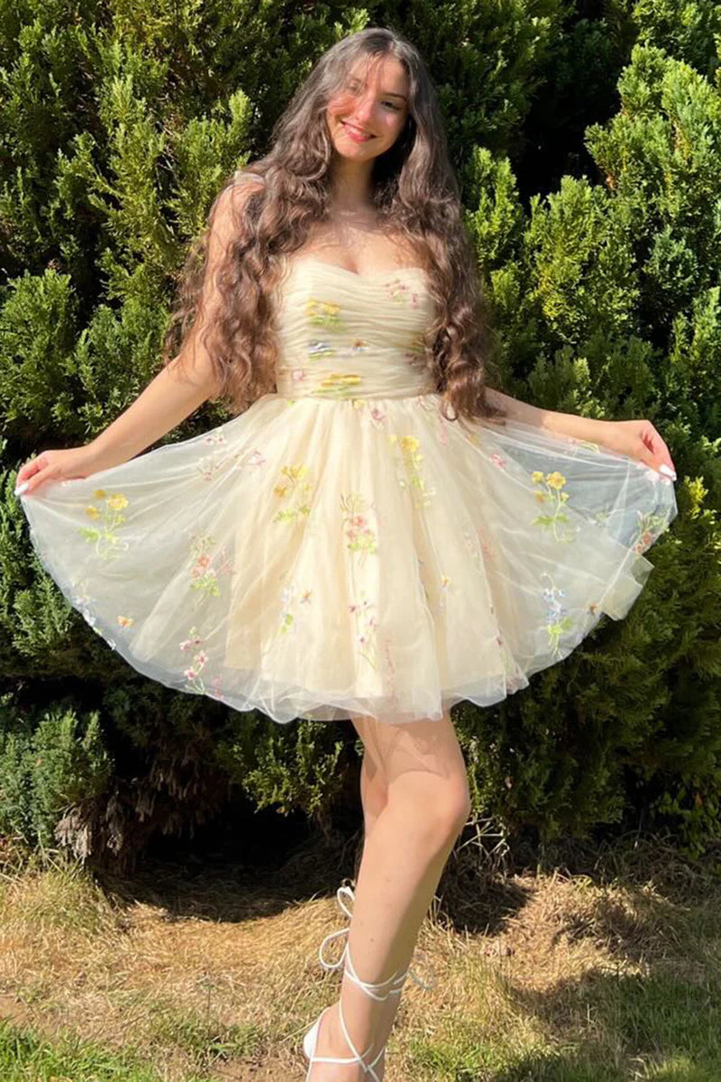 Model wearing an elegant A-line short homecoming dress with floral embroidery and spaghetti straps, front view.