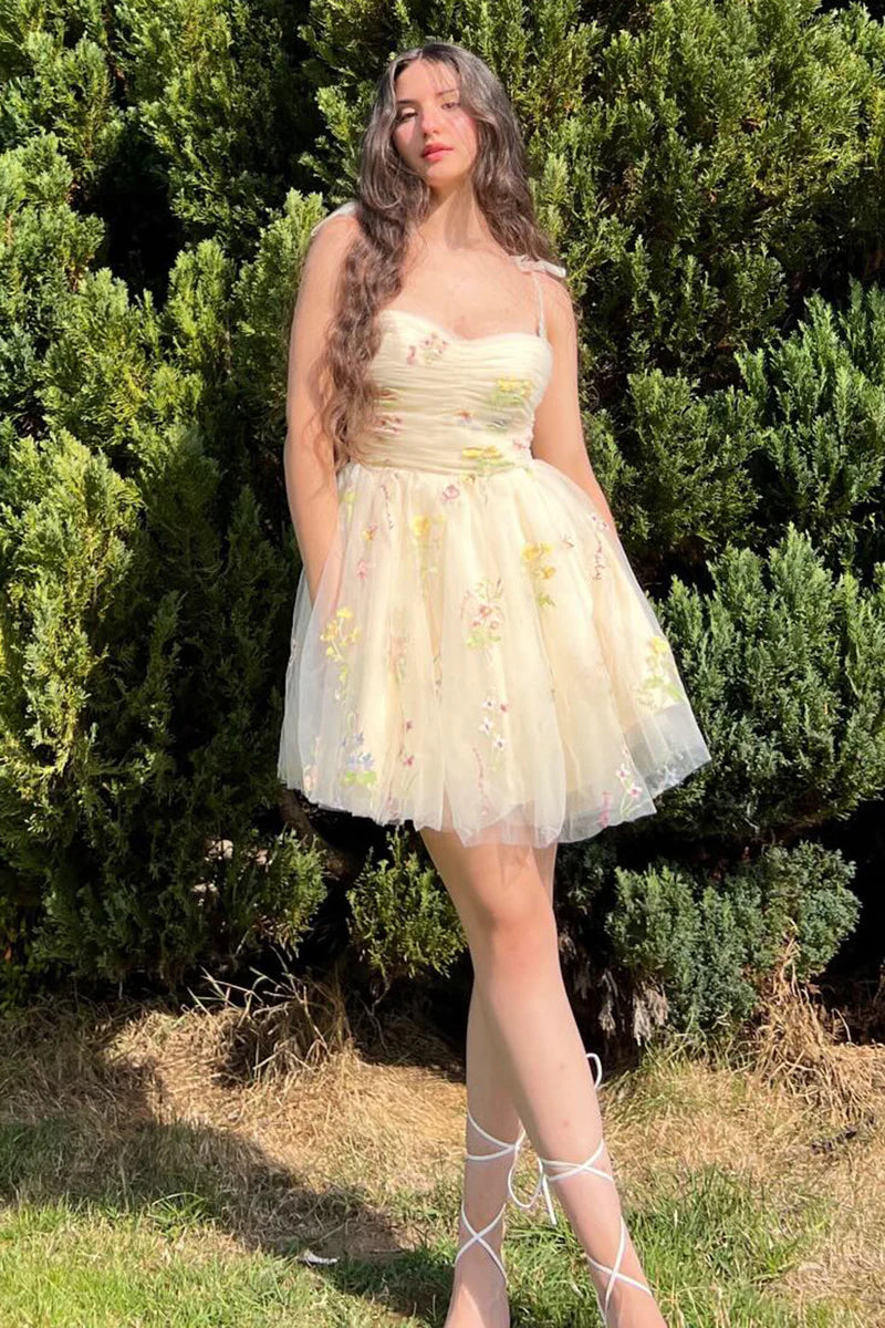 Close-up of the floral embroidery and spaghetti straps on the A-line short homecoming dress.