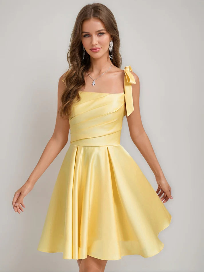 A-Line square neck pleated mini homecoming dress with a bow.