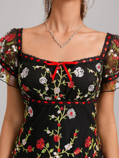 Close-up of the square neckline and puff sleeves on the embroidered homecoming dress.