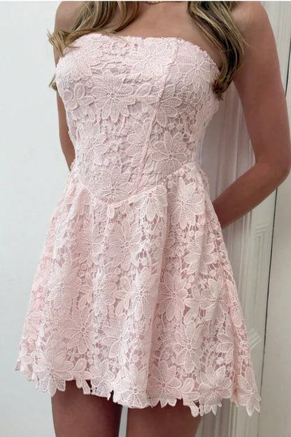Close-up of floral lace detail on blush pink mini dress.