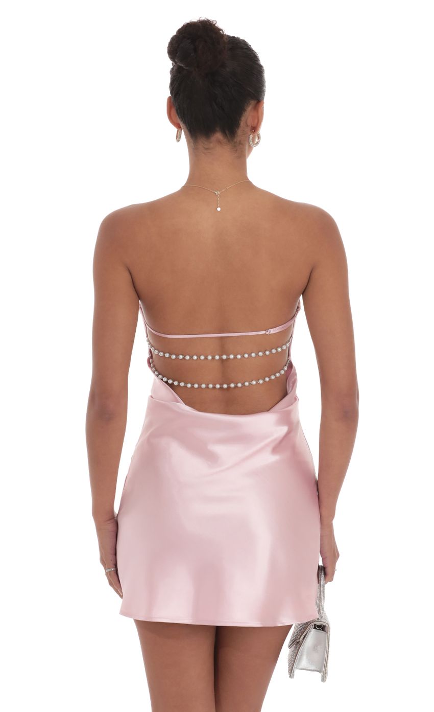 Side view of the blush pink satin mini dress, showing the flared A-line skirt.