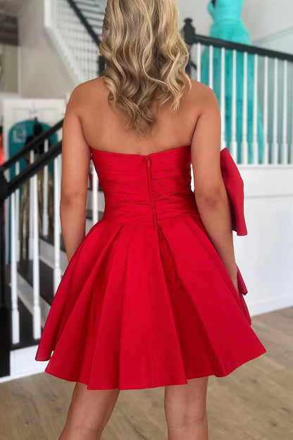Back view of a red A-line strapless short homecoming dress with a bow.