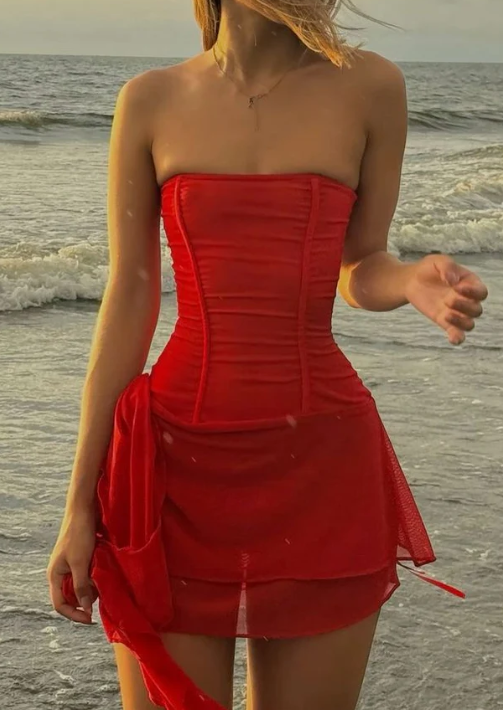 Model wearing an elegant red A-line strapless short formal dress.