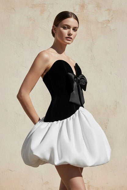 Close-up of the soft velvet fabric and satin bow detail on the dress.