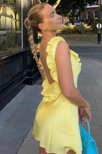 Back view of a yellow short satin dress with ruffled details.