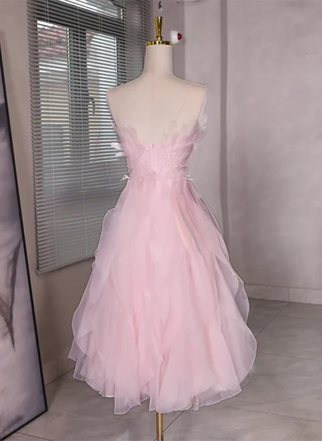 Close-up of the beaded bodice and low back detail of the pink tulle dress.