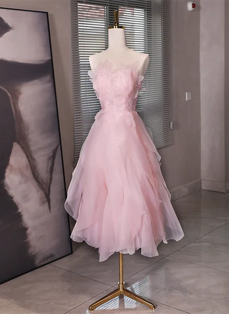 Back view of the pink tulle dress, highlighting the low back design.
