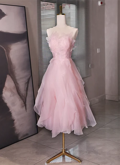 Back view of the pink tulle dress, highlighting the low back design.