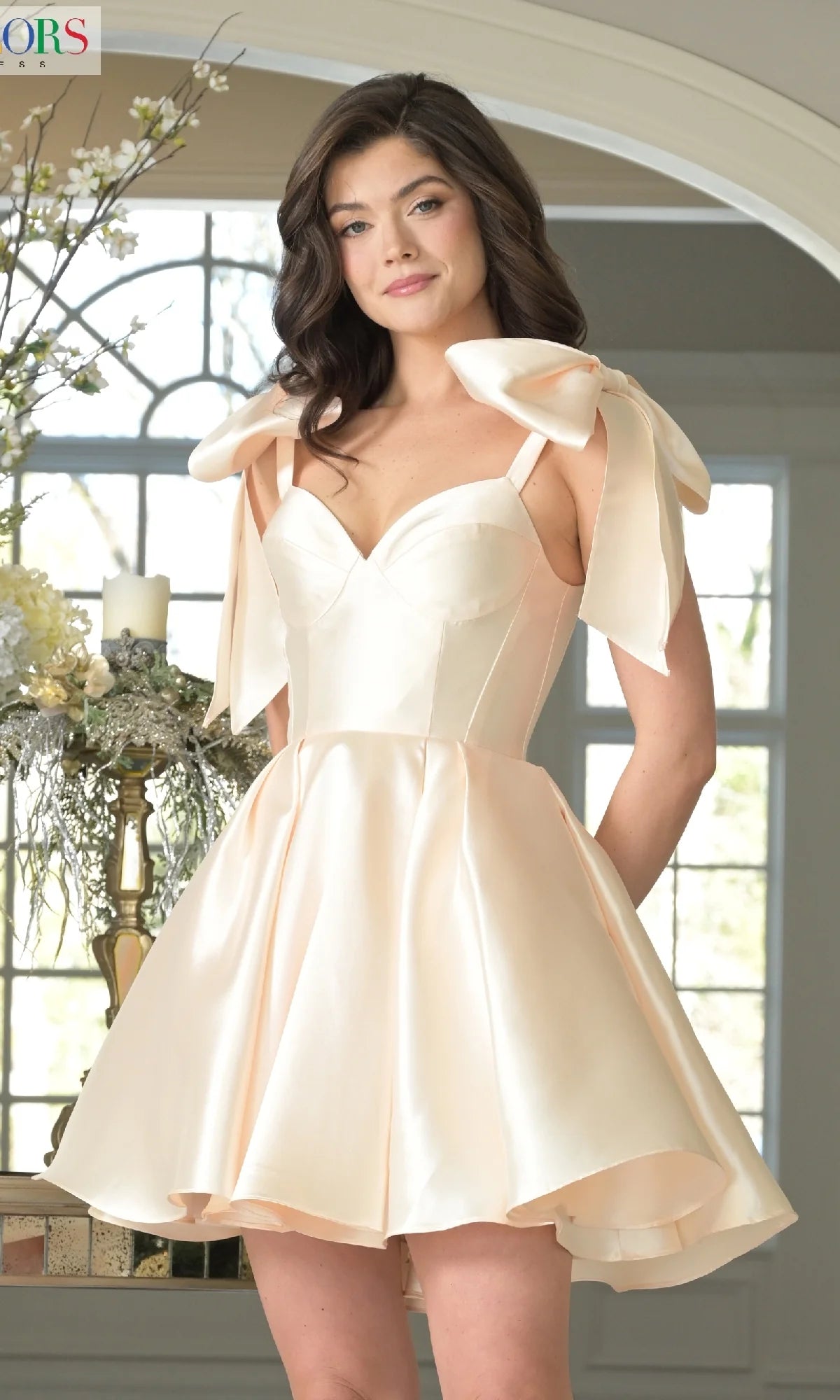 Champagne A-line homecoming dress with bow straps and lace-up back.