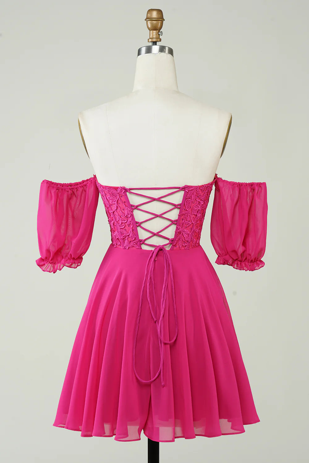Side view of fuchsia chiffon A-line dress with delicate lace details.