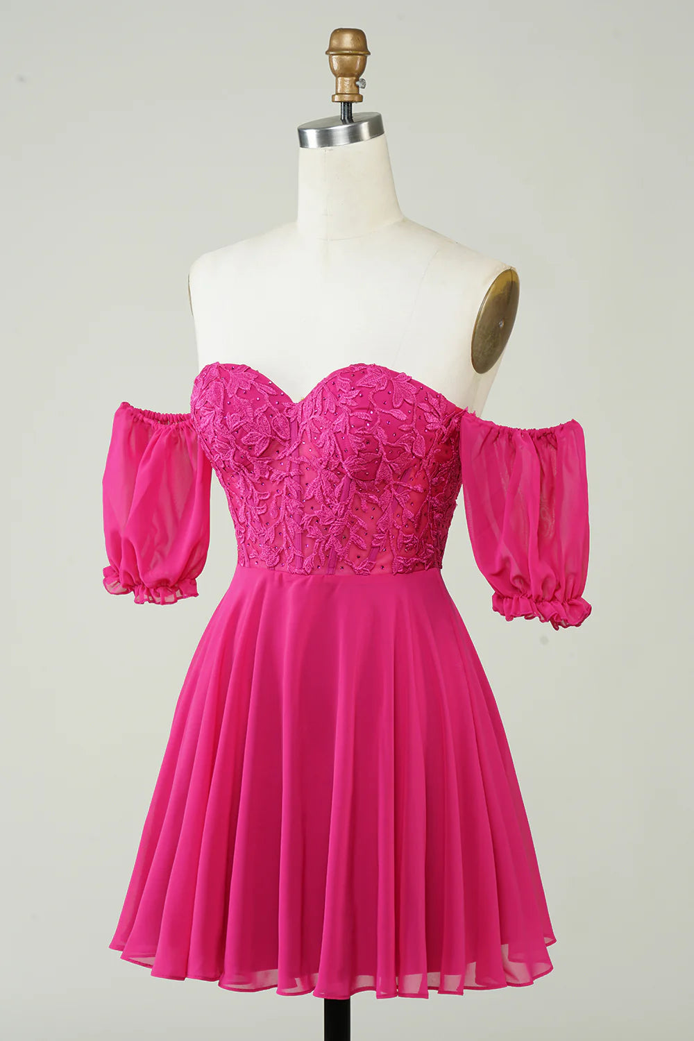 Back view of fuchsia formal gown showing corset lacing and flowing skirt.