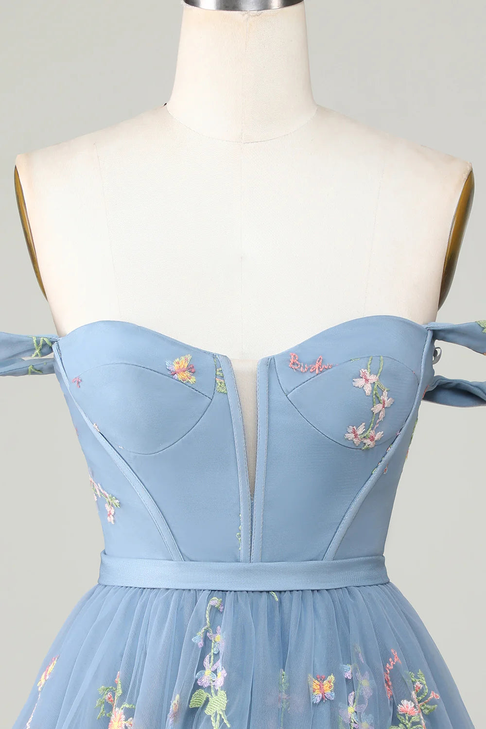 Close-up of embroidery detail on A-line dress.