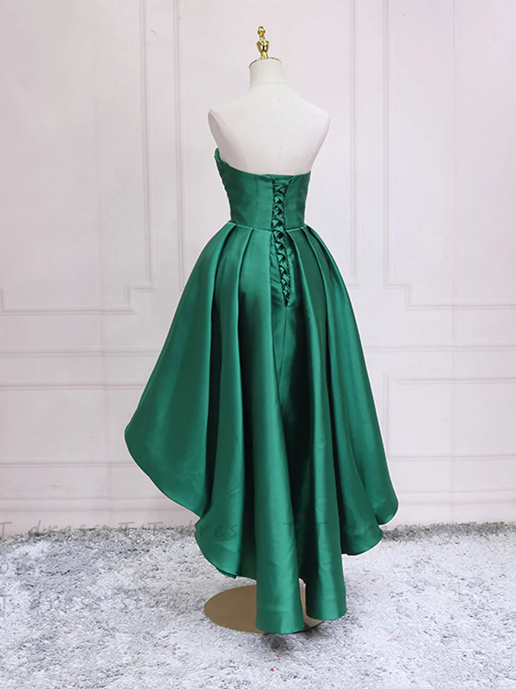 Back view of a green A-line high-low homecoming dress with sweetheart neckline.