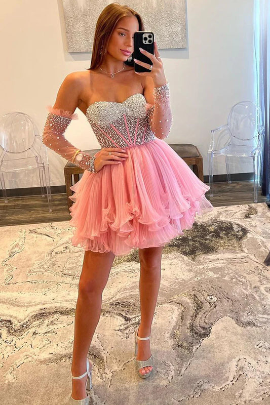 Model wearing an elegant pink A-line sweetheart long sleeve beaded homecoming gown.