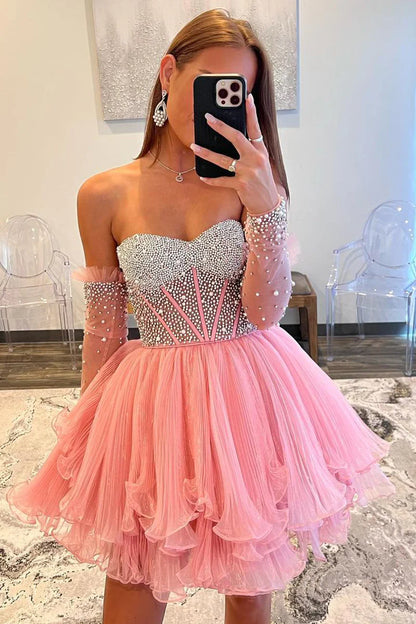 Close-up of the pink A-line sweetheart long sleeve beaded homecoming gown, showing intricate beading details.